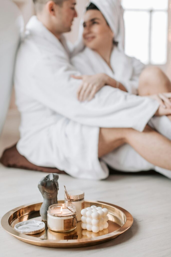 Cozy spa scene with couple embracing and aromatherapy candles creating a serene atmosphere.